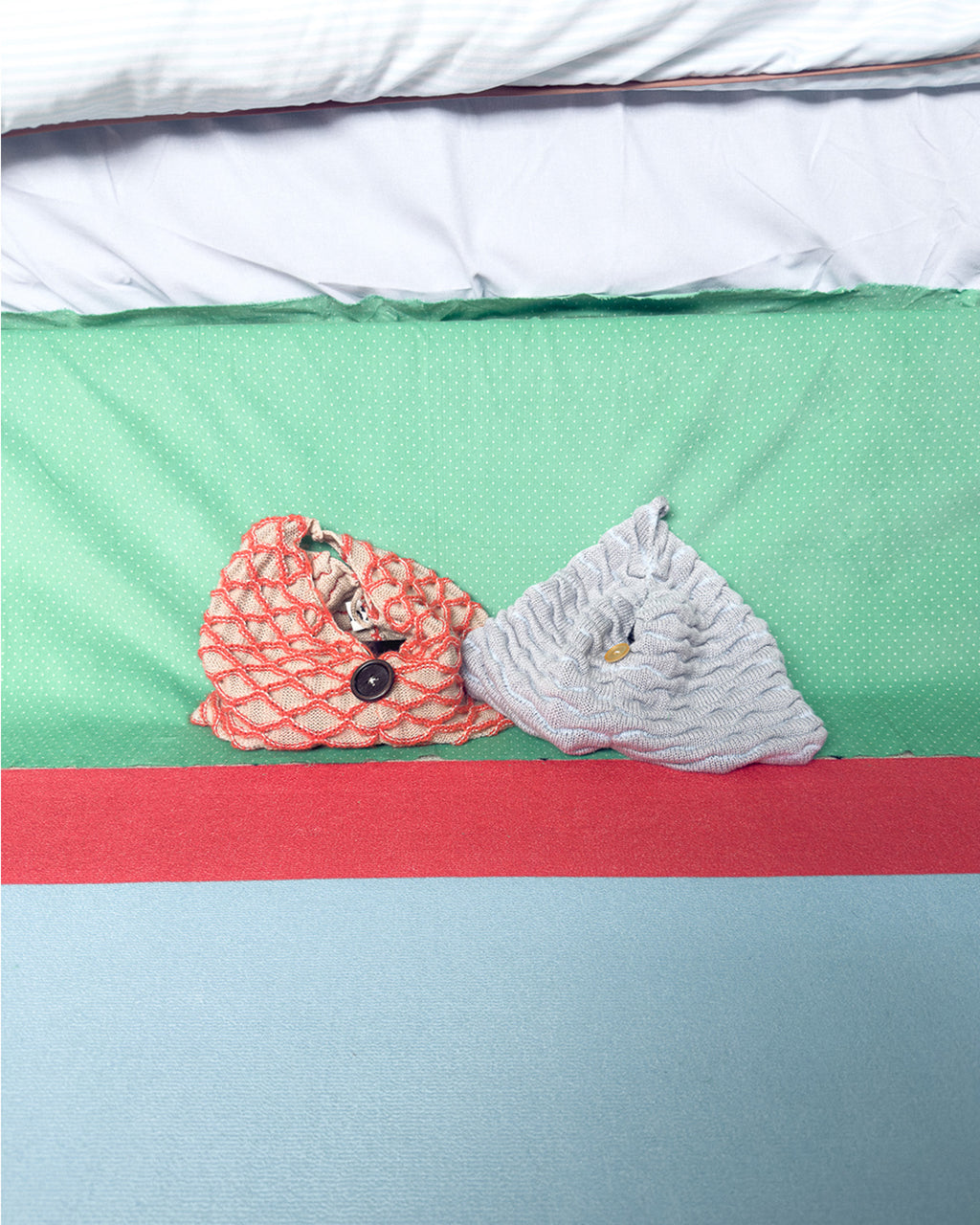 Two handmade knit bags in grey and beige with orange net detail, soft textured shapes displayed on colorful background