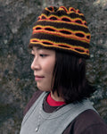 3d knit beanie with textured pattern worn on model
close-up of reversible knit beanie in brown and yellow stripes
side profile of wool mohair beanie with sculptural texture