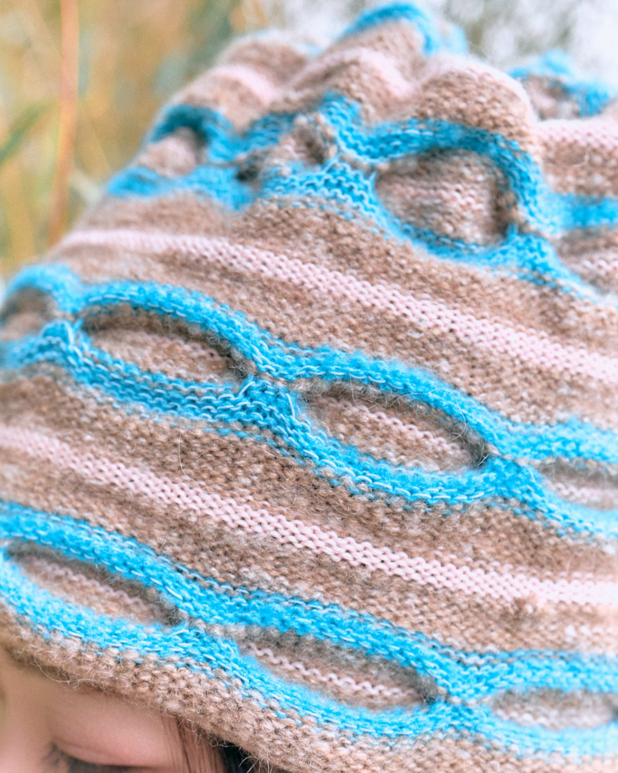 3d knit beanie with textured pattern worn on model
close-up of reversible knit beanie in brown and yellow stripes
side profile of wool mohair beanie with sculptural texture