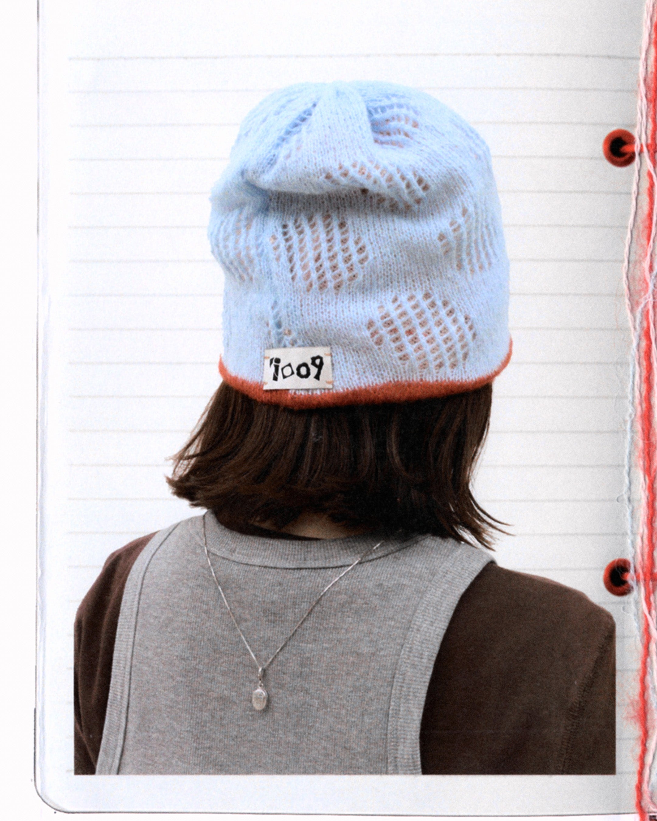 mesh knit beanie with breathable texture worn from back
light blue open knit hat with soft structure
close-up of airy knit beanie with perforated pattern