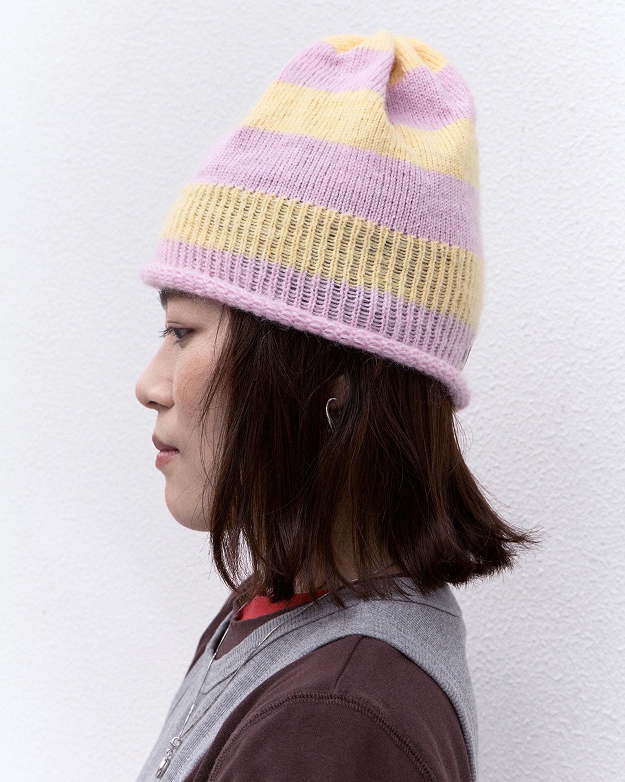 soft knit beanie in pastel color worn on model
close-up of wool mohair beanie with stripe pattern
side profile of lightweight knit hat with soft texture